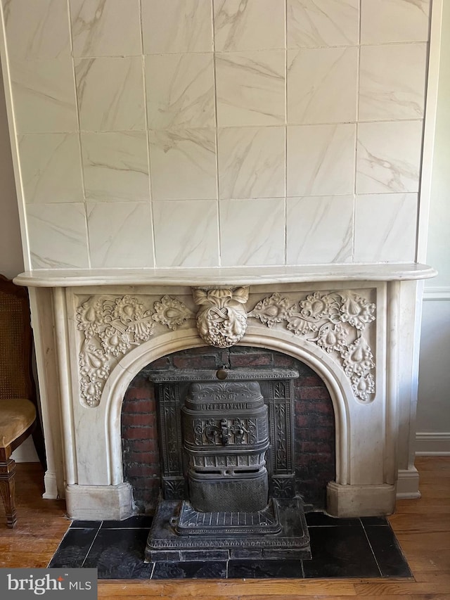 interior details featuring a wood stove and hardwood / wood-style floors