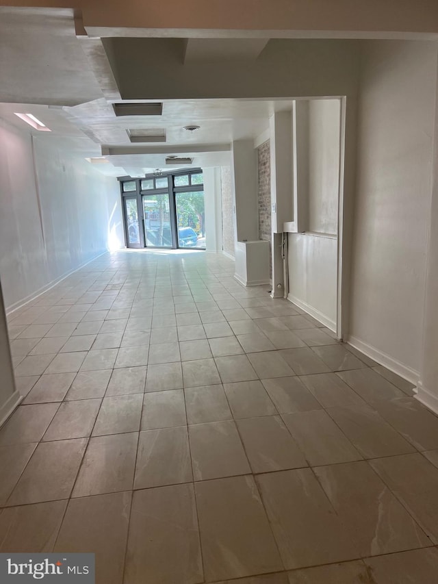 unfurnished room with light tile patterned floors