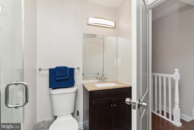 bathroom with vanity, hardwood / wood-style flooring, and toilet