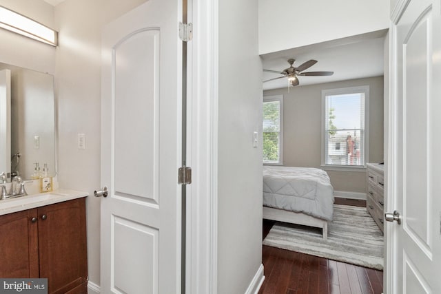 bathroom featuring ceiling fan, vanity, and wood-type flooring