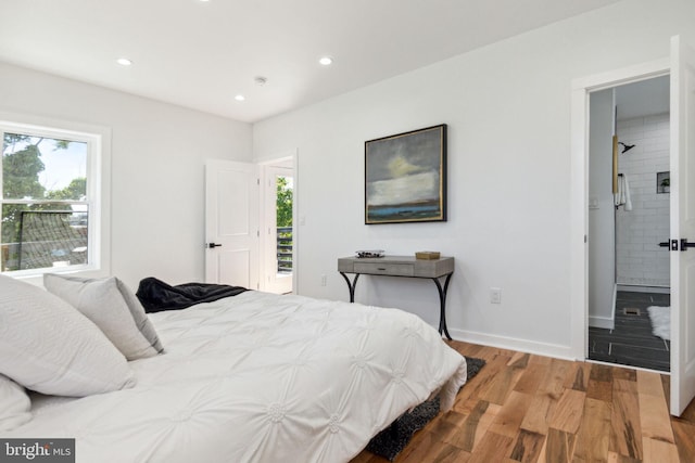 bedroom featuring ensuite bathroom and wood-type flooring