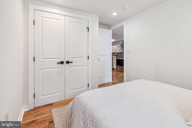 bedroom featuring wood-type flooring and a closet