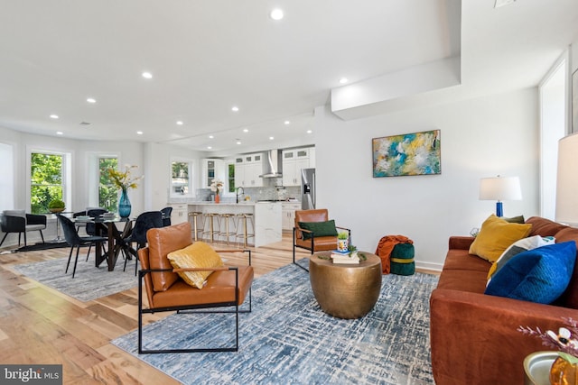 living room with sink and light hardwood / wood-style flooring