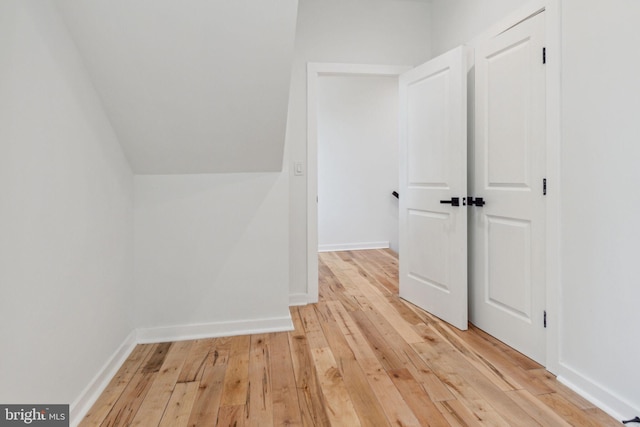 additional living space with light hardwood / wood-style flooring