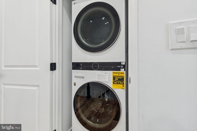 laundry area featuring stacked washer and clothes dryer