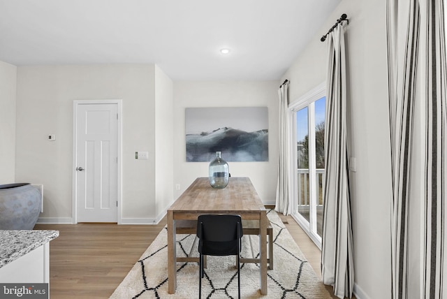 dining space featuring light wood-type flooring