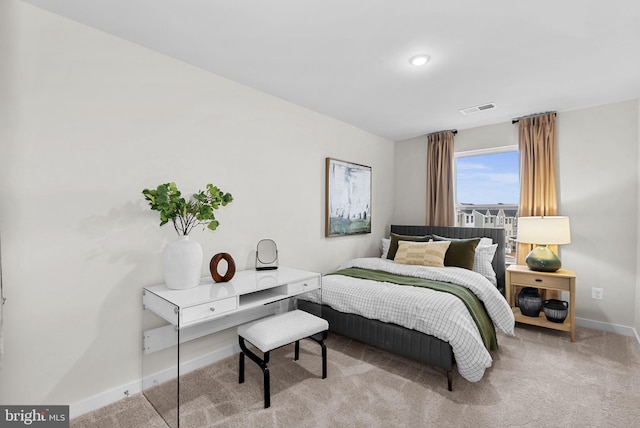 bedroom with light colored carpet