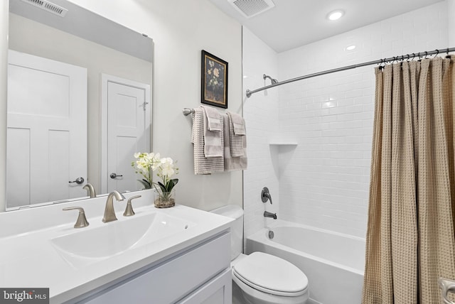 full bathroom featuring toilet, shower / bath combination with curtain, and vanity