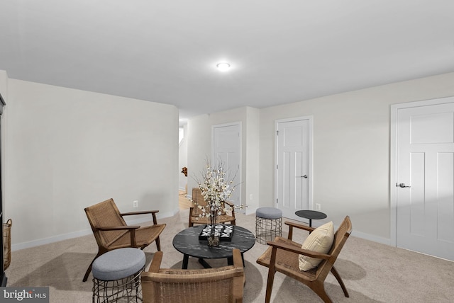 sitting room featuring light colored carpet