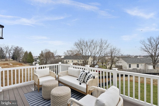 wooden terrace with an outdoor living space