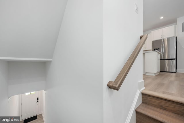 stairway with hardwood / wood-style floors