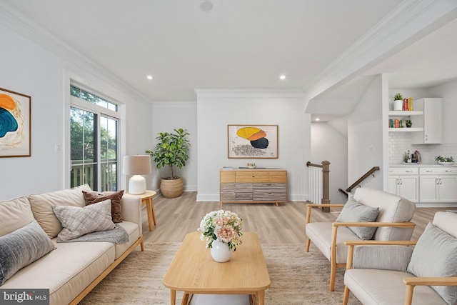 living room with crown molding and light hardwood / wood-style flooring