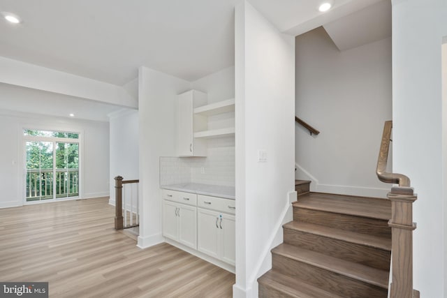 stairway featuring wood-type flooring