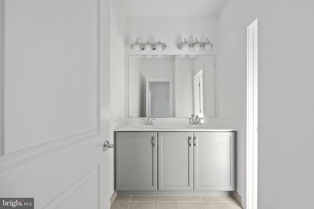 bathroom with tile patterned flooring and vanity