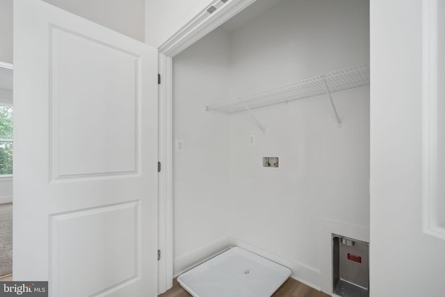 laundry area featuring hookup for a washing machine and hardwood / wood-style floors