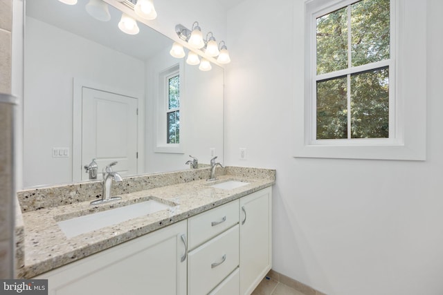 bathroom with tile patterned floors, a wealth of natural light, and vanity