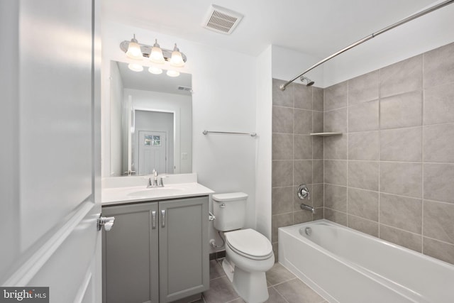 full bathroom with vanity, tile patterned floors, tiled shower / bath combo, and toilet