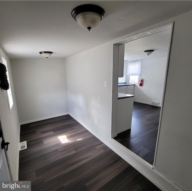 spare room featuring dark wood-type flooring