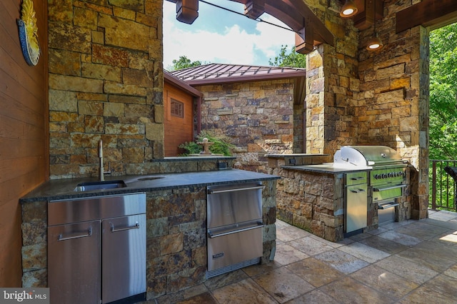 view of patio / terrace with area for grilling and sink