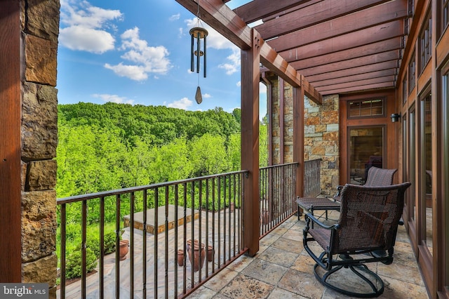 balcony featuring a pergola