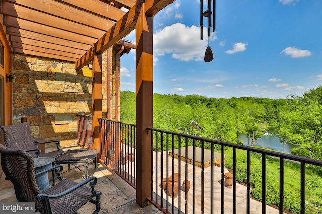 balcony with a pergola and a water view