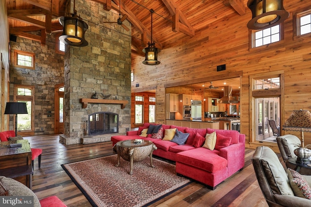 living room with beamed ceiling, high vaulted ceiling, a wealth of natural light, and wooden ceiling