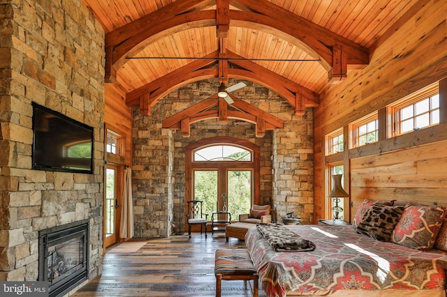 unfurnished bedroom featuring high vaulted ceiling, multiple windows, and dark wood-type flooring