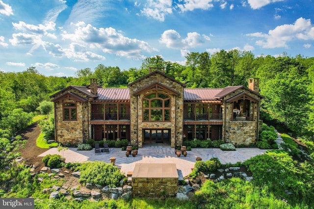 rear view of property featuring a patio area