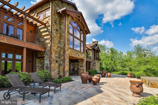 view of patio featuring a balcony