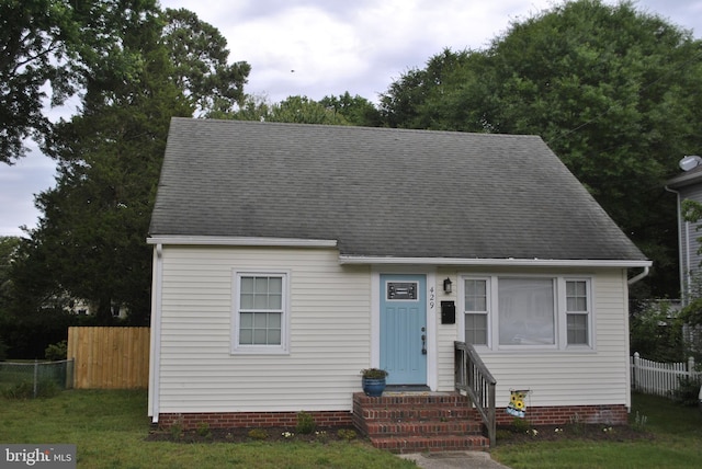 cape cod-style house with a front lawn