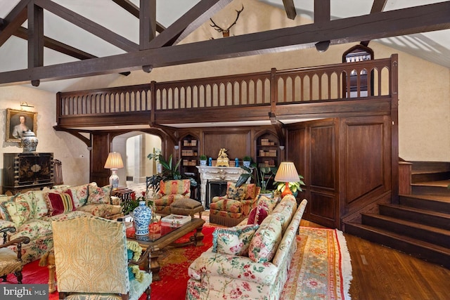 living room featuring beamed ceiling, high vaulted ceiling, and hardwood / wood-style flooring