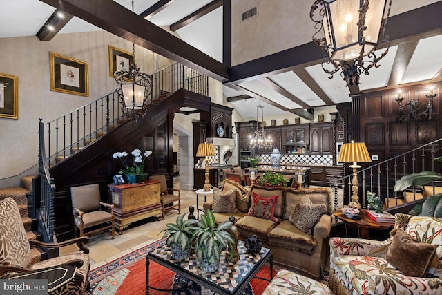 living room with vaulted ceiling with beams, light tile patterned flooring, and an inviting chandelier