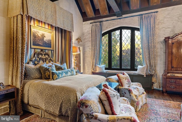 bedroom featuring lofted ceiling with beams and dark hardwood / wood-style floors