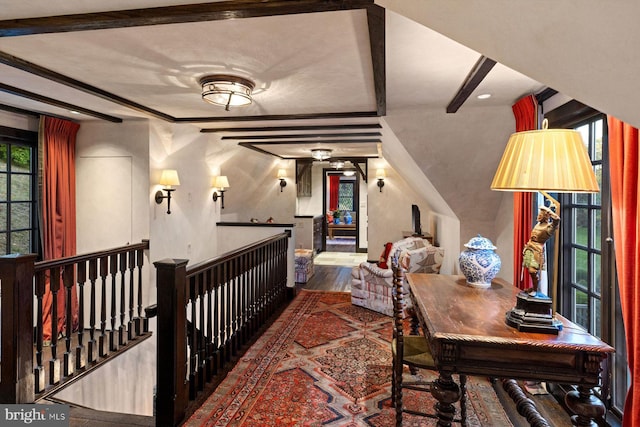 bedroom featuring hardwood / wood-style floors and beamed ceiling