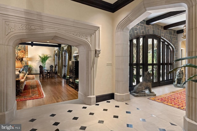 entrance foyer with beam ceiling, hardwood / wood-style flooring, french doors, and crown molding