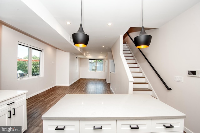 kitchen with decorative light fixtures, dark hardwood / wood-style flooring, and white cabinetry