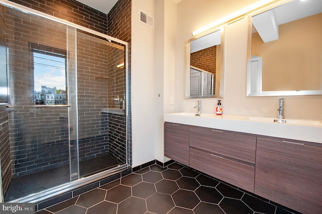 bathroom featuring tile patterned floors, vanity, and an enclosed shower