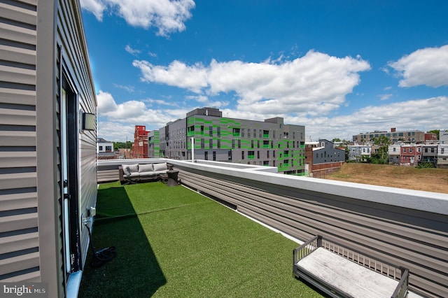 view of yard with a balcony