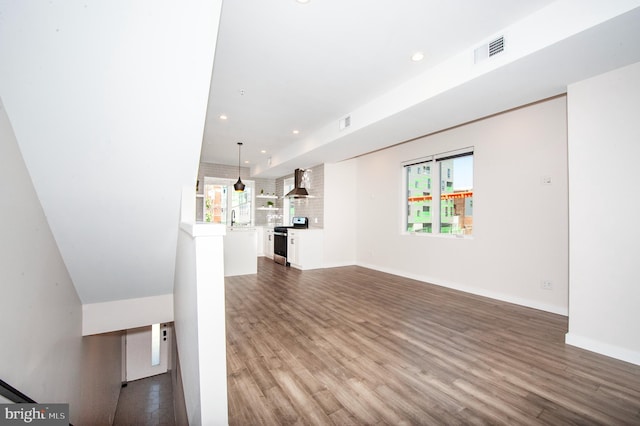 unfurnished living room with dark hardwood / wood-style flooring and sink