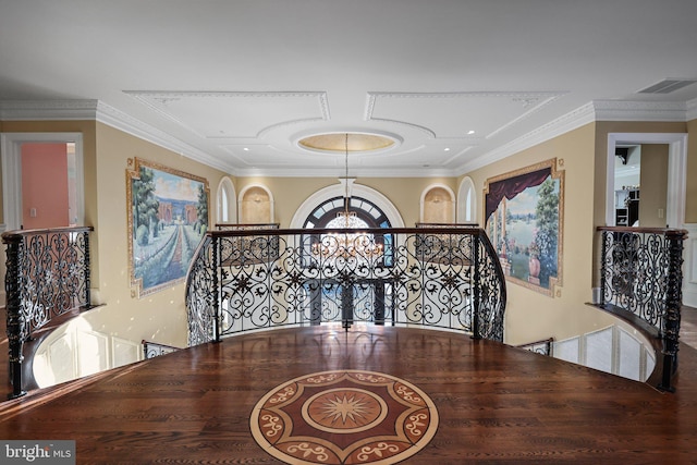 hall featuring crown molding and an inviting chandelier