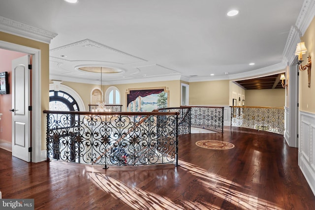 hall with a chandelier, wood-type flooring, and crown molding