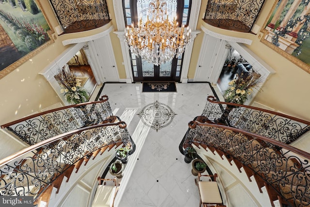 entrance foyer featuring french doors and an inviting chandelier