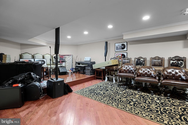 playroom with crown molding and hardwood / wood-style floors