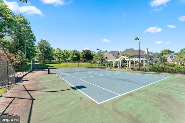 view of sport court featuring a pergola and basketball hoop