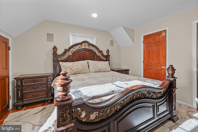 bedroom featuring dark hardwood / wood-style floors and lofted ceiling