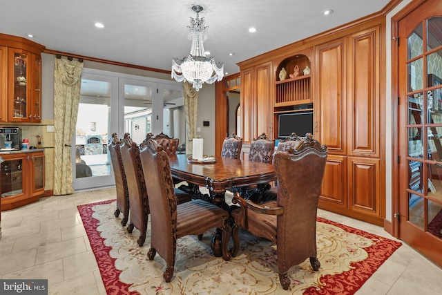 tiled dining room featuring a chandelier and ornamental molding