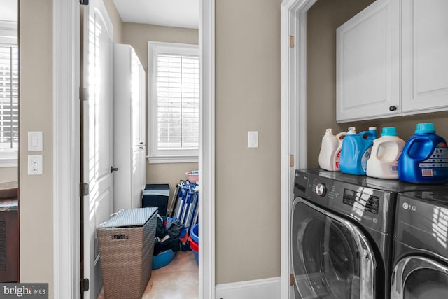 clothes washing area featuring washer and dryer, tile patterned flooring, and cabinets