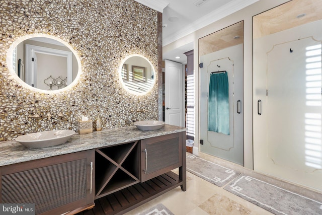 bathroom with crown molding and vanity