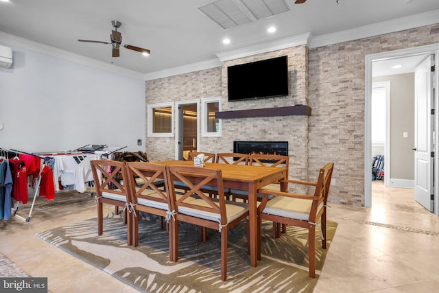 dining area with a wall unit AC, ceiling fan, a fireplace, and ornamental molding