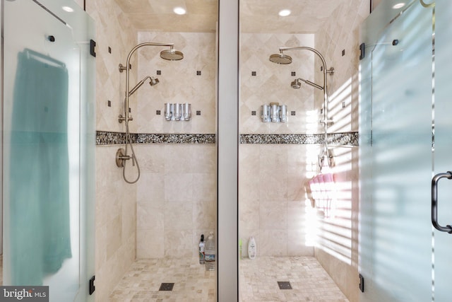 bathroom featuring a shower with shower door